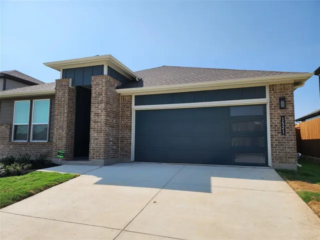 a front view of a house with garage
