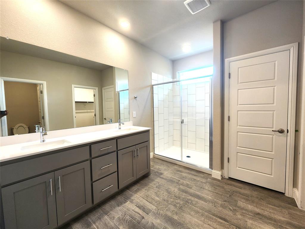 1521 Razorbill Road Denton, TX 76205 - Photo 22 of 31 a spacious bathroom with a double vanity sink and large mirror