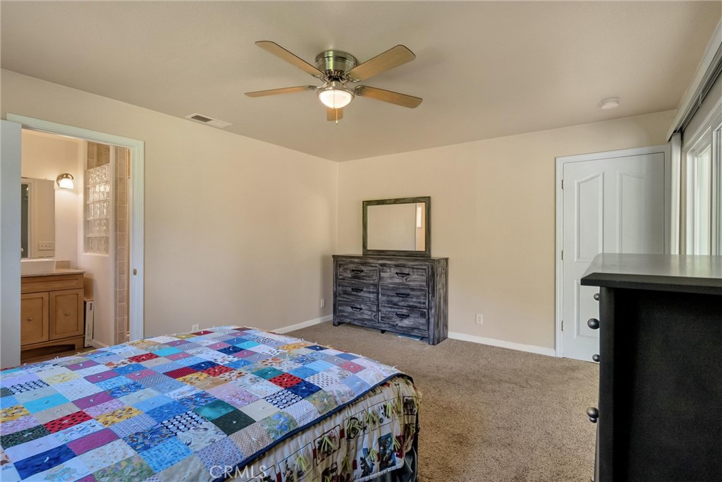 1394 Wagstaff Road Paradise, CA 95969 - Photo 18 of 46 a bedroom with a bed and a chandelier