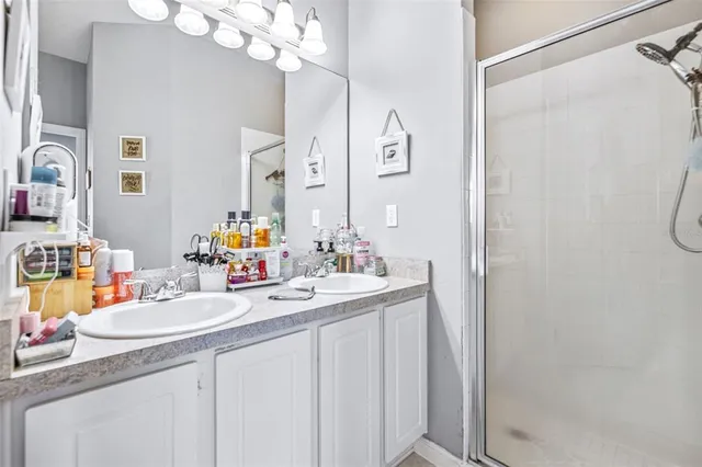 a bathroom with a sink vanity granite and a mirror