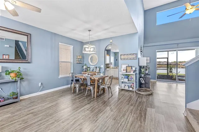 a dining room with furniture and wooden floor