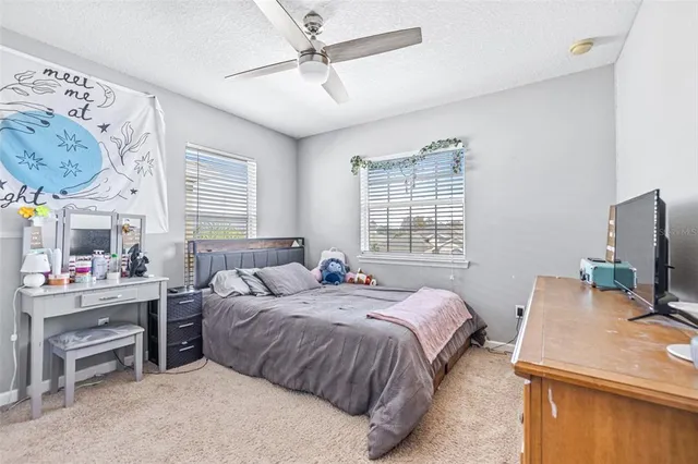 a bedroom with a bed and a table in it