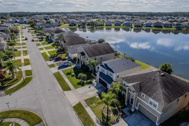 an aerial view of a house with outdoor space and lake view