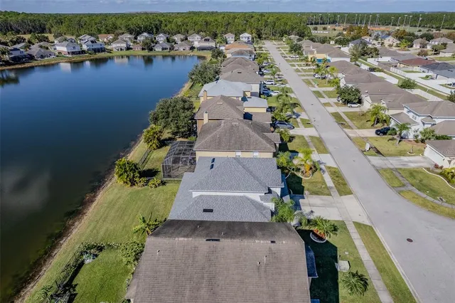 an aerial view of a house with a lake view