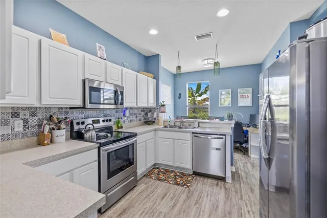 a kitchen with a sink stove and refrigerator