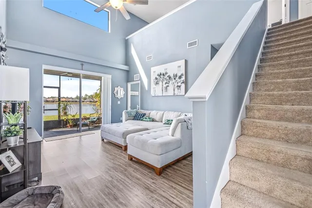 a bedroom with furniture and a large window