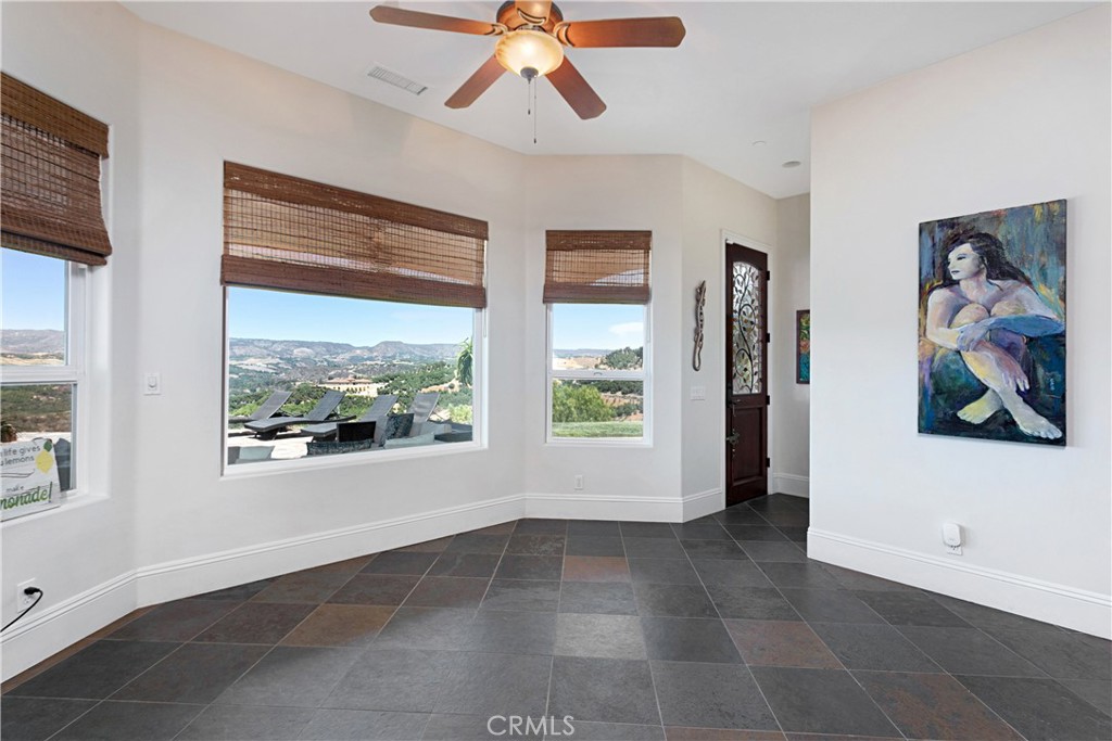 4106 Rock Mountain Road Fallbrook, CA 92028 - Photo 12 of 36 a view of a livingroom with a window and a ceiling fan