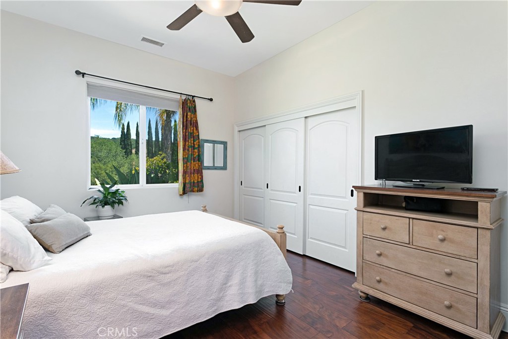 4106 Rock Mountain Road Fallbrook, CA 92028 - Photo 18 of 36 a bedroom with a bed and a flat screen tv