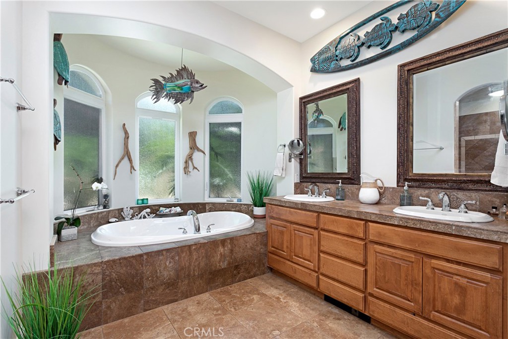 4106 Rock Mountain Road Fallbrook, CA 92028 - Photo 26 of 36 a spacious bathroom with a double vanity sink large mirror and a bathtub