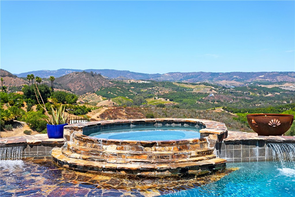 4106 Rock Mountain Road Fallbrook, CA 92028 - Photo 29 of 36 a view of a swimming pool with a lounge chair