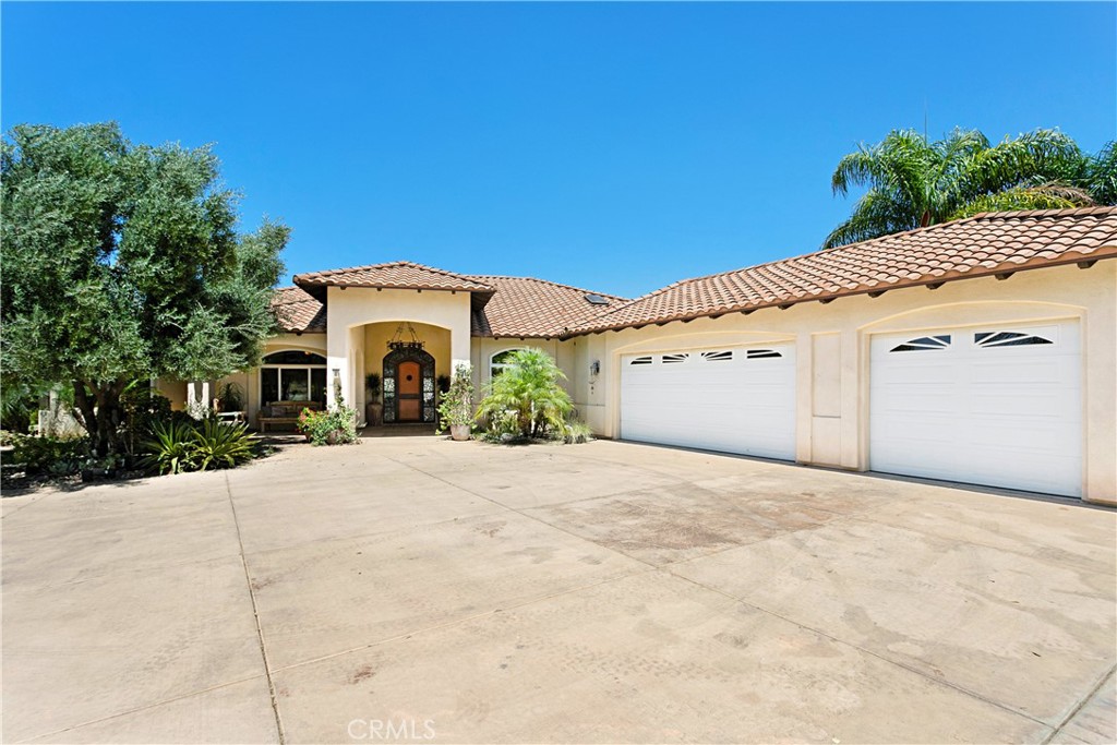 4106 Rock Mountain Road Fallbrook, CA 92028 - Photo 34 of 36 a view of a house with a yard and garage