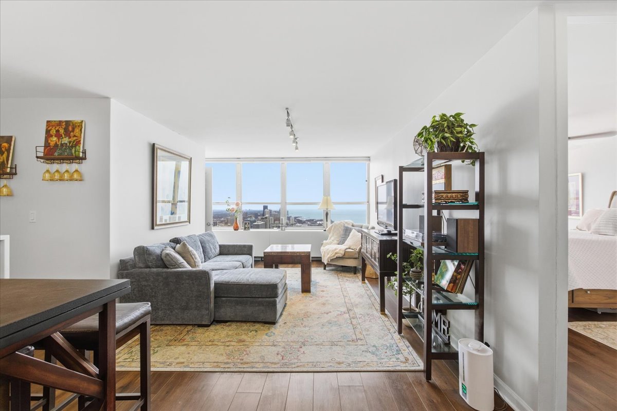 655 West Irving Park Road, Unit 4412 Chicago, IL 60613 - Photo 2 of 19 a living room with furniture kitchen view and a large window