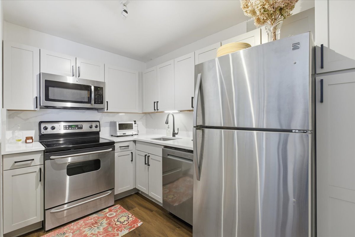 655 West Irving Park Road, Unit 4412 Chicago, IL 60613 - Photo 5 of 19 a kitchen with stainless steel appliances a refrigerator sink and microwave