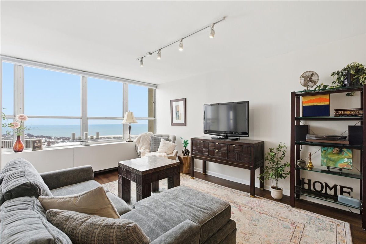 655 West Irving Park Road, Unit 4412 Chicago, IL 60613 - Photo 6 of 19 a living room with furniture and a flat screen tv