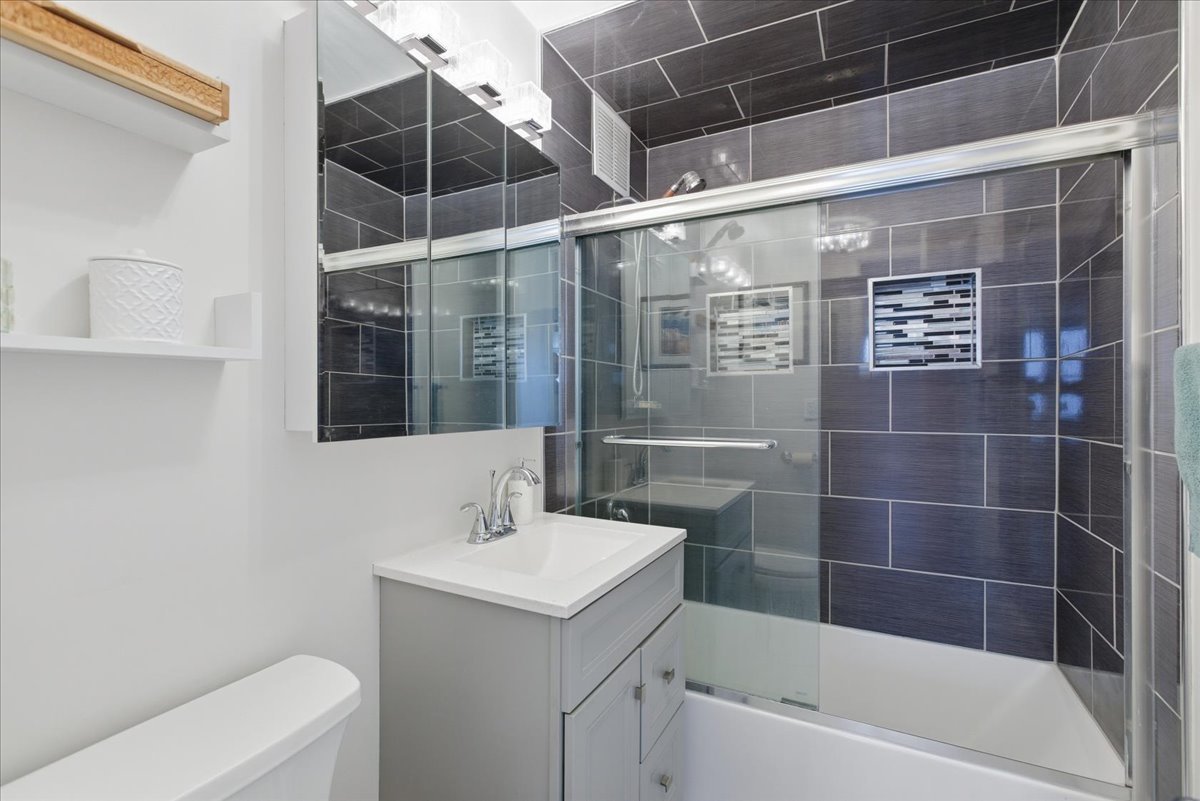 655 West Irving Park Road, Unit 4412 Chicago, IL 60613 - Photo 10 of 19 a bathroom with a bathtub and shower