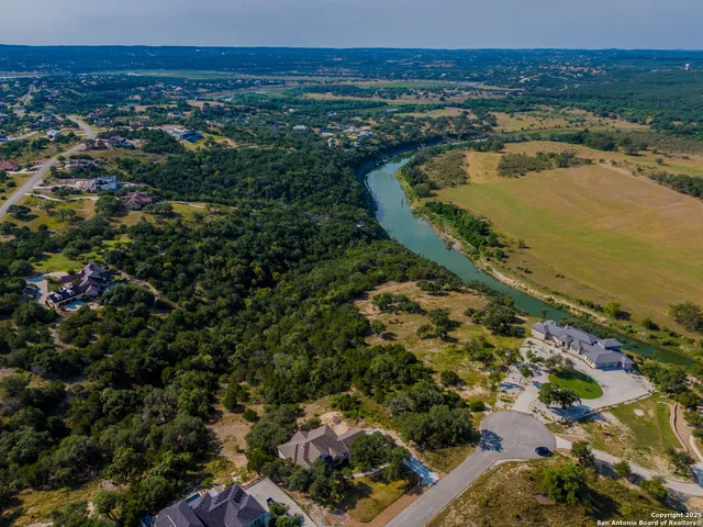 an aerial view of a house with a yard
