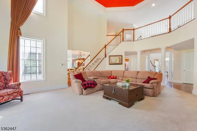 a living room with furniture and stairs