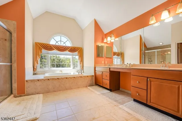 a large bathroom with a large tub and sink