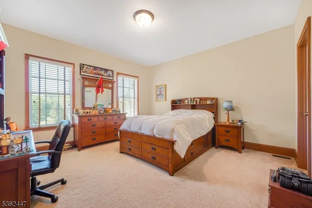 a bed room with a bed and a chair