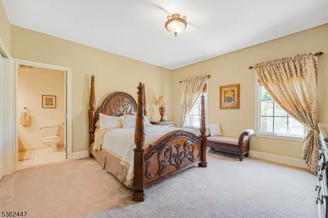 a bedroom with bed and a large window