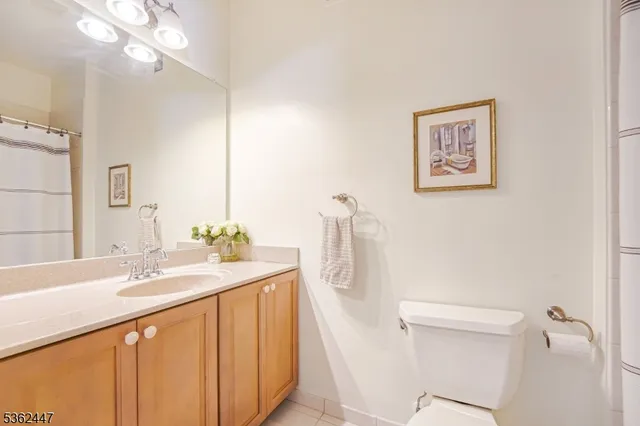 a bathroom with a sink a toilet a mirror and shower