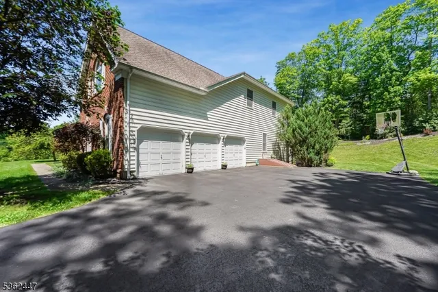 a view of a house with a yard and garage