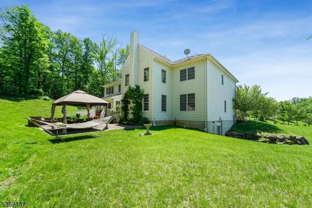 a view of a house with a yard and sitting area