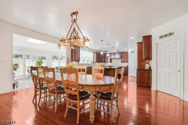 a dining room with furniture window and wooden floor