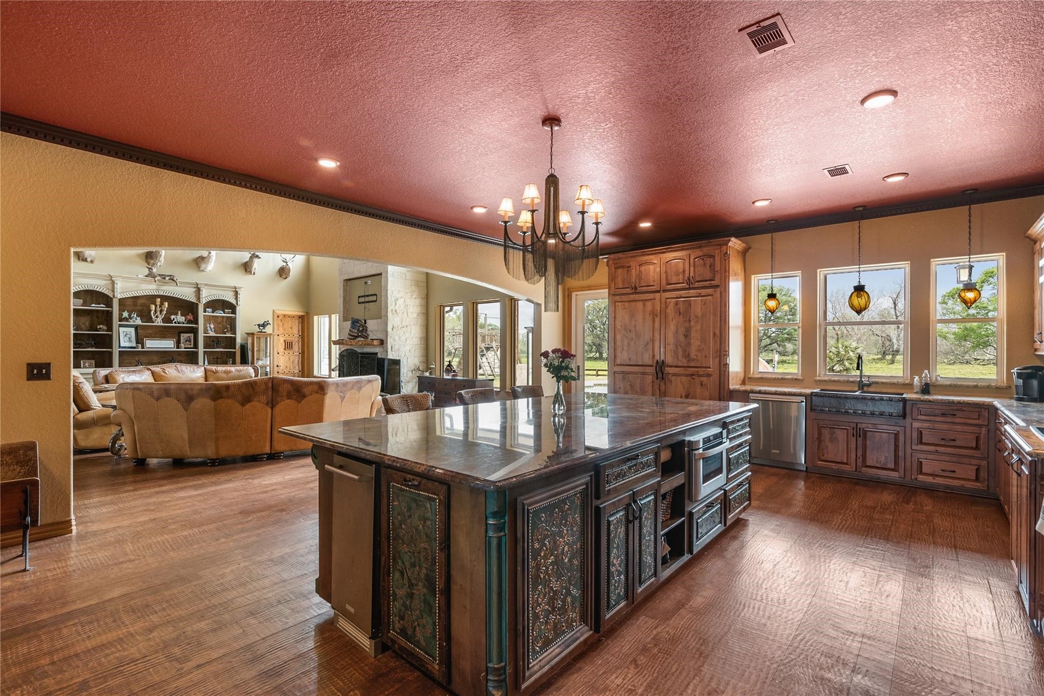 8821 FM 524 Road Sweeny, TX 77480 - Photo 19 of 47 a large kitchen with stainless steel appliances a large counter top a stove and a wooden floors