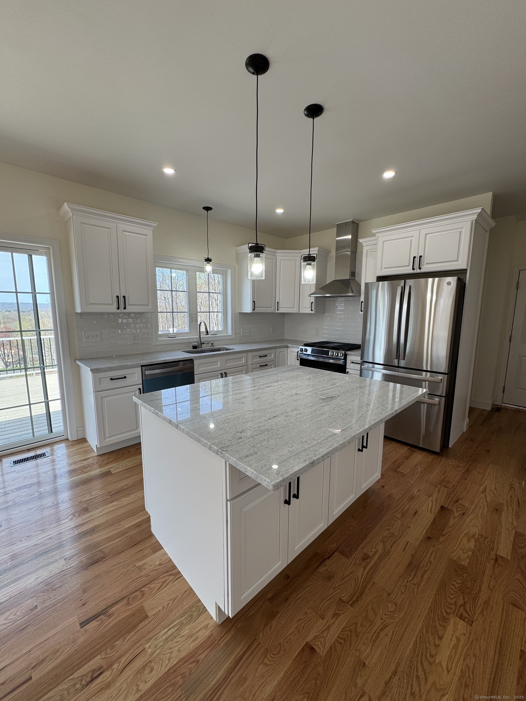 274 Riverside Drive Meriden, CT 06451 - Photo 1 of 7 a large kitchen with stainless steel appliances granite countertop a stove a sink a refrigerator and wooden floor