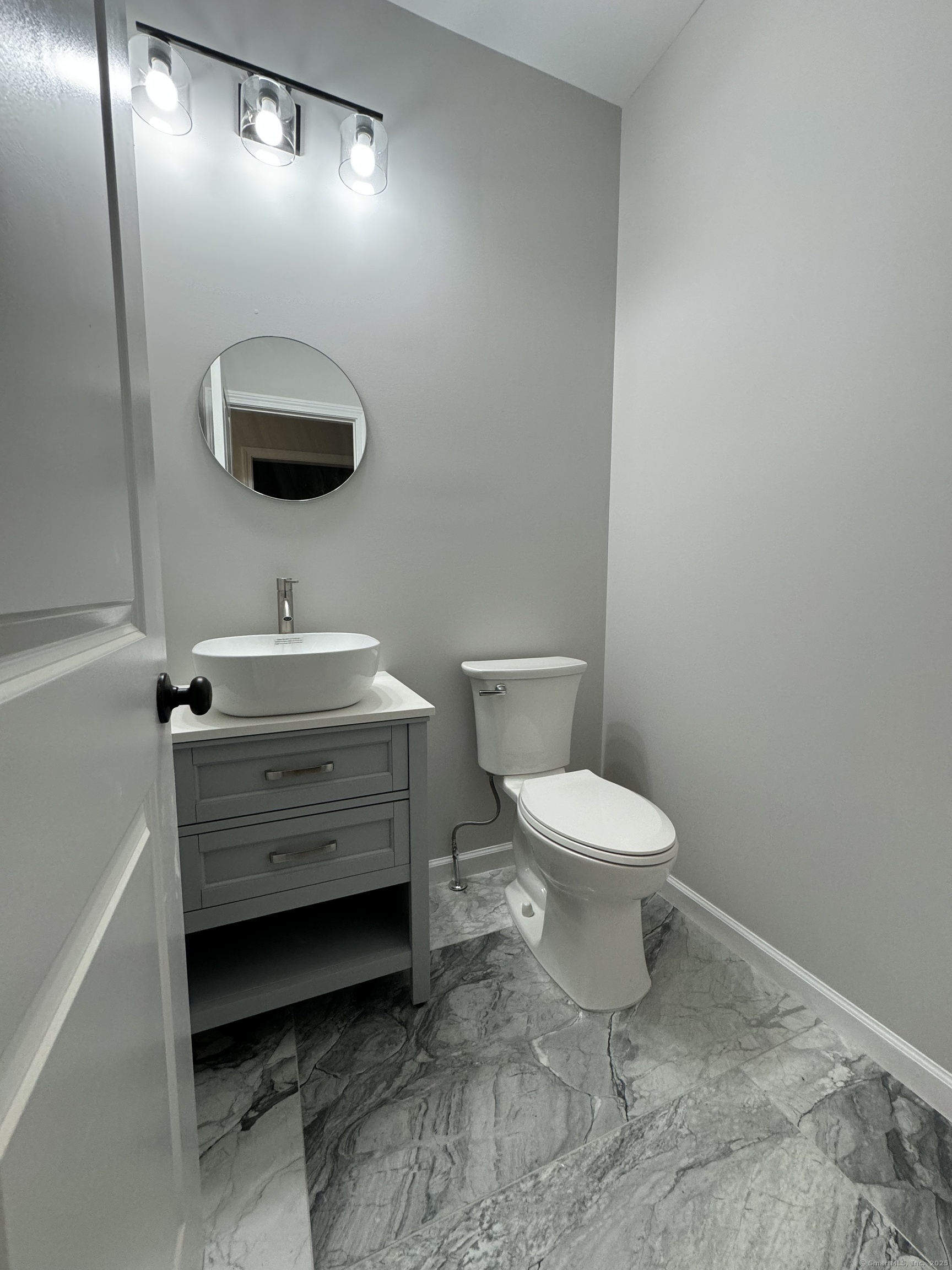 274 Riverside Drive Meriden, CT 06451 - Photo 7 of 7 a bathroom with a toilet a sink and mirror