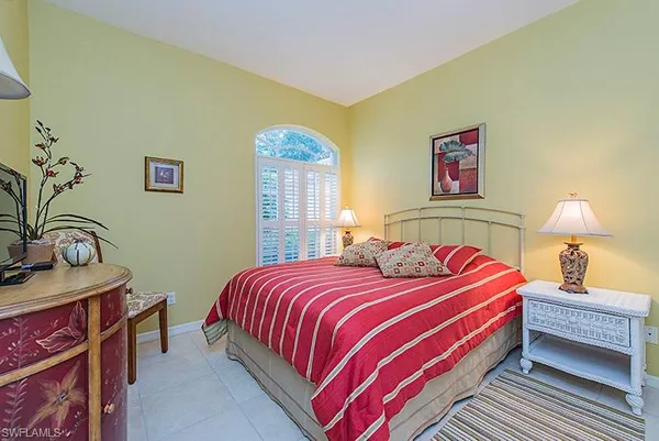 a bedroom with a bed and a table in it