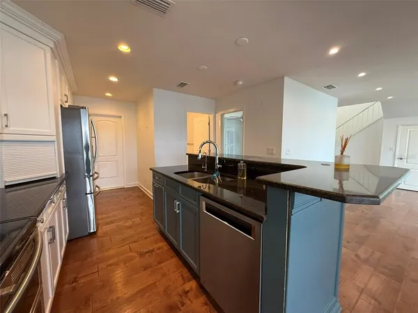 a view of hallway with a large window and wooden floor