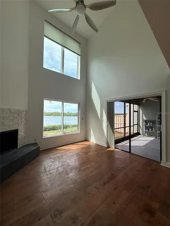 a view of empty room with fireplace and fan
