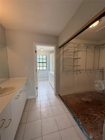 a spacious bathroom with a sink and a mirror