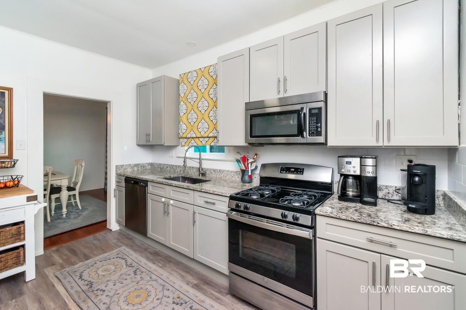 116 Item Avenue Mobile, AL 36607 - Photo 14 of 33 Kitchen with light hardwood / wood-style flooring, appliances with stainless steel finishes, sink, and light stone counters
