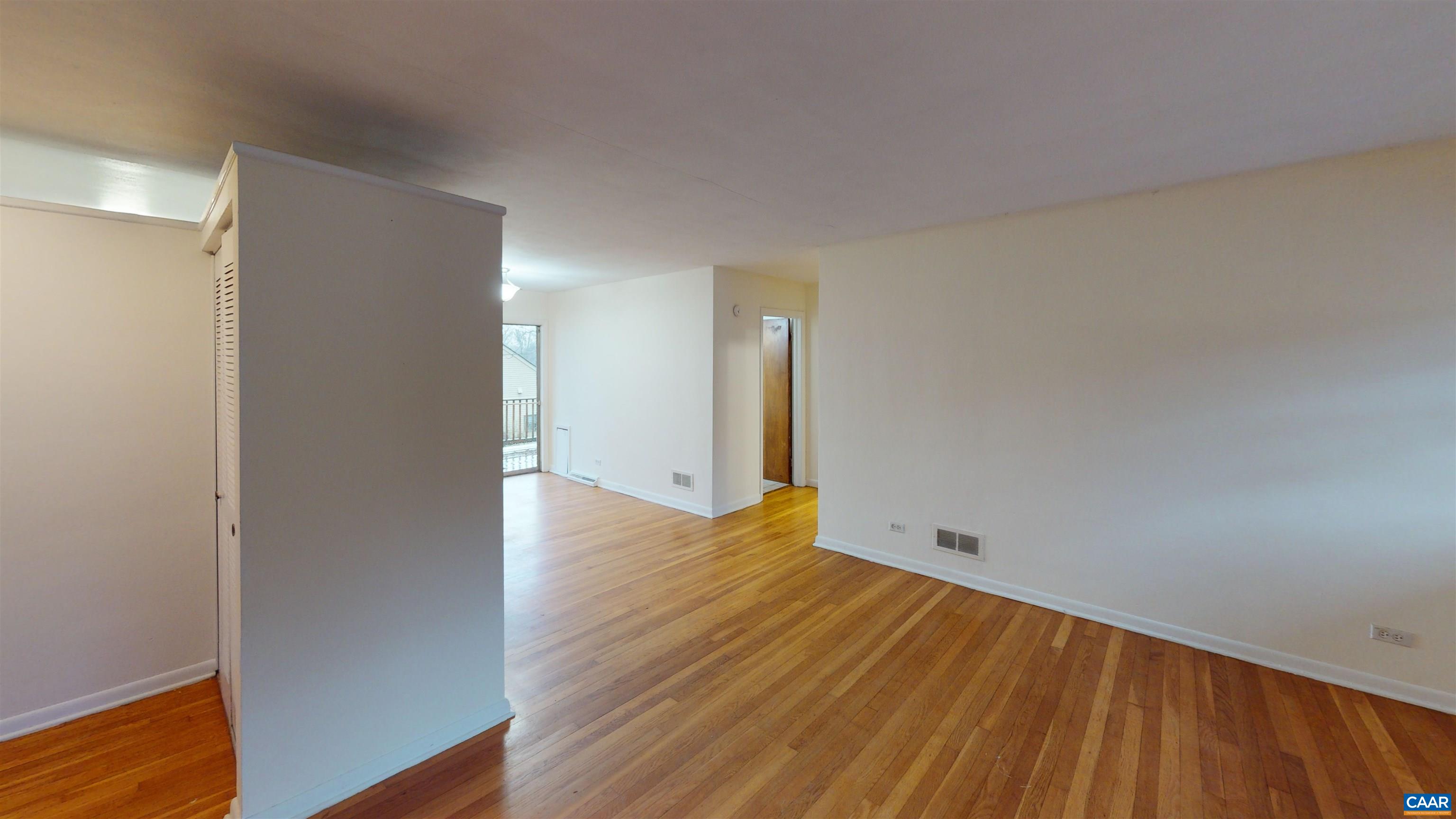 130 Apple Tree Road, Unit A Charlottesville, VA 22903 - Photo 14 of 16 a view of an empty room with wooden floor