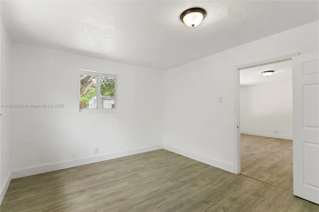 an aerial view of residential houses with outdoor space and street view