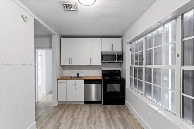 an aerial view of a house with a yard and garden space