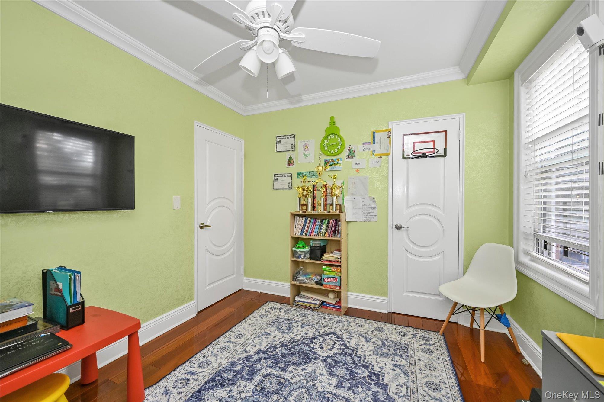 97-37 63rd Road, Unit 2J Queens, NY 11374 - Photo 14 of 19 a living room with furniture and a flat screen tv