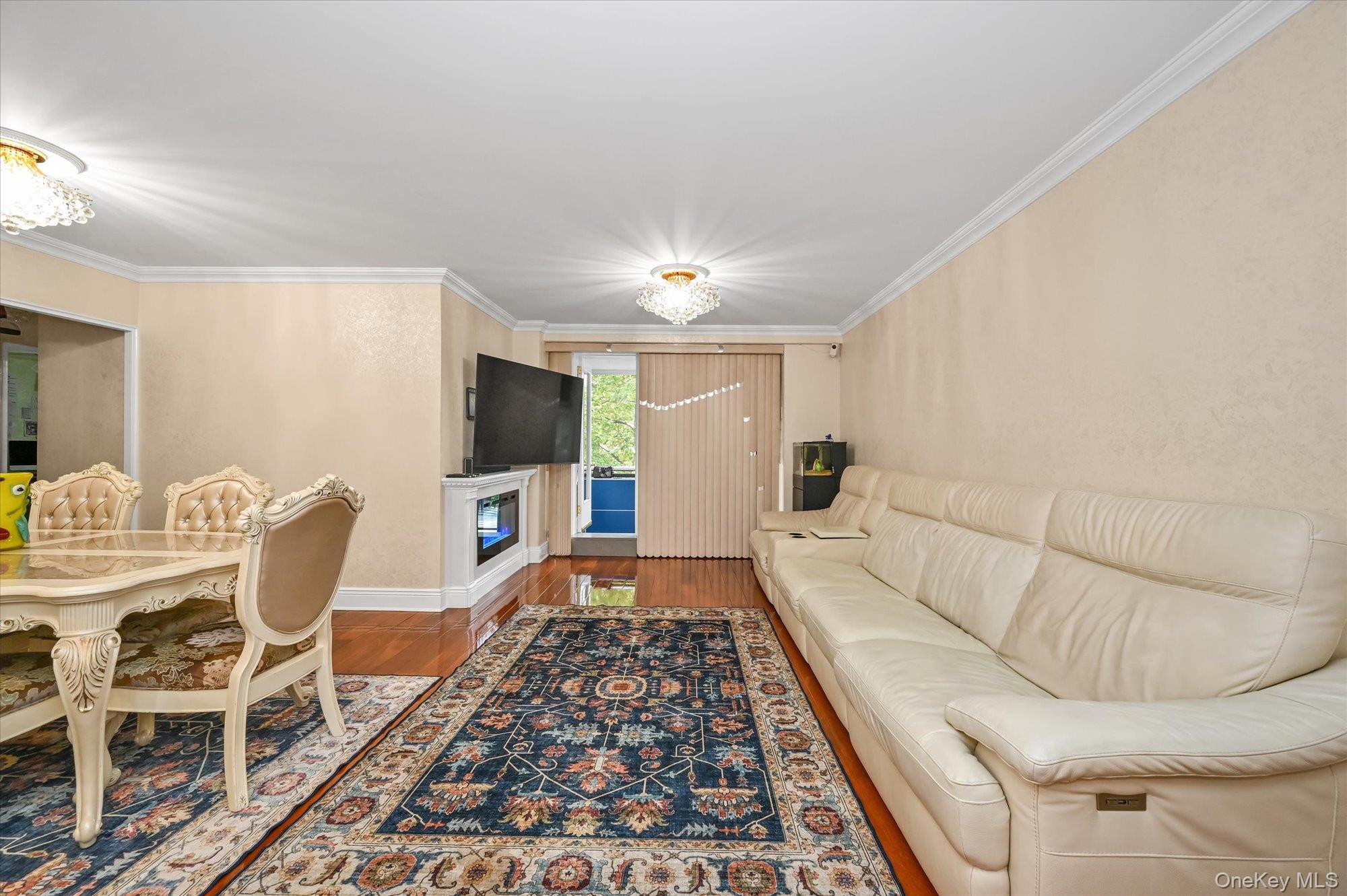 97-37 63rd Road, Unit 2J Queens, NY 11374 - Photo 3 of 19 a living room with furniture and a rug