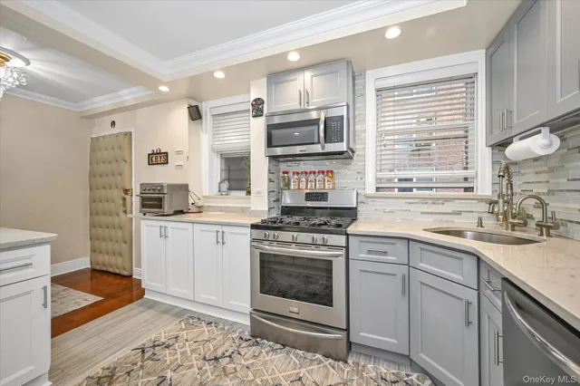 a kitchen with stainless steel appliances granite countertop a stove and a sink