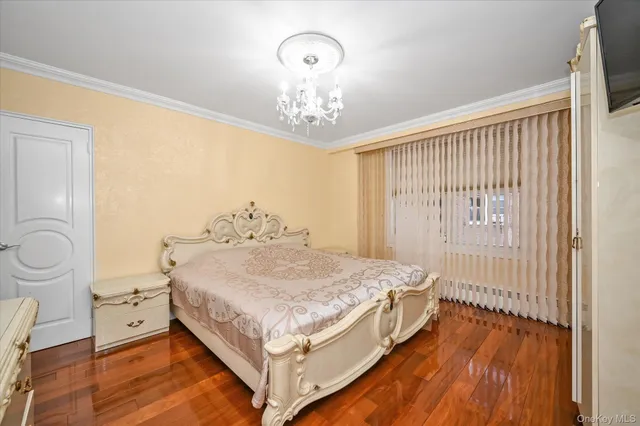 a bedroom with a bed and a chandelier