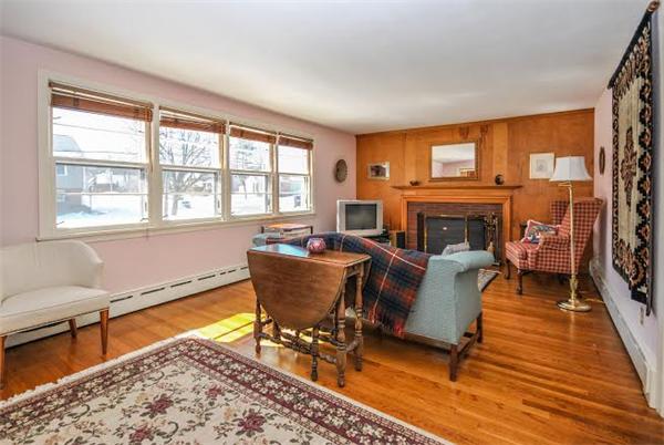 36 Hunting Road Needham, MA 02494 - Photo 2 of 11 a living room with furniture a fireplace and a table