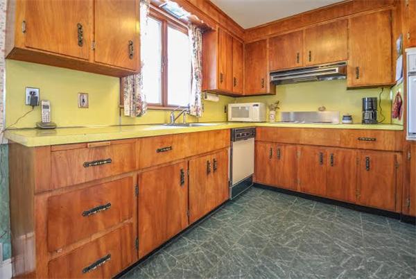 36 Hunting Road Needham, MA 02494 - Photo 4 of 11 a kitchen with granite countertop a sink stainless steel appliances and cabinets