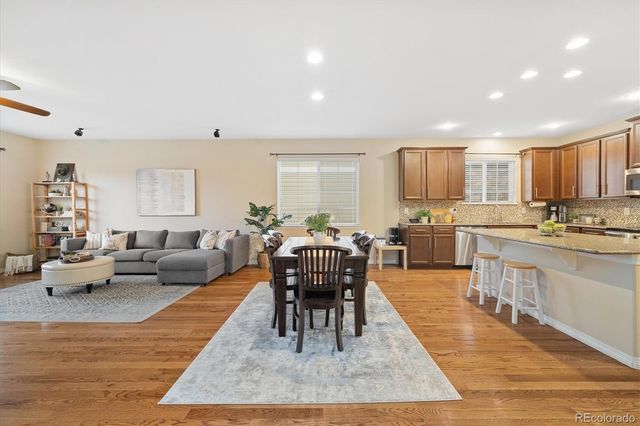 a living room with furniture wooden floor and a view of kitchen