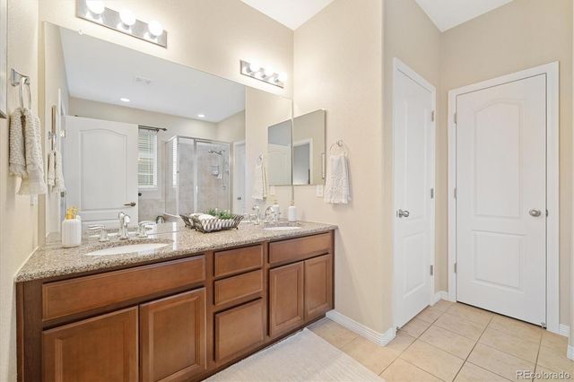 a bathroom with a double vanity sink and mirror