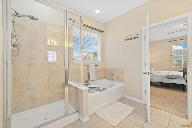 a bathroom with a tub a sink and a shower