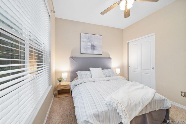 a bedroom with a bed and a large window