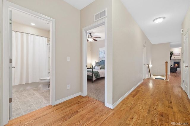 a view of a hallway view with wooden floor and furniture